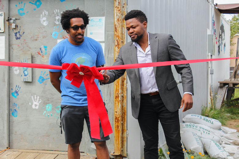 Adam Powers (left) and Edwin Wanji (right) at the ribbon-cutting ceremony to open Shark Garden’s solar microgrid