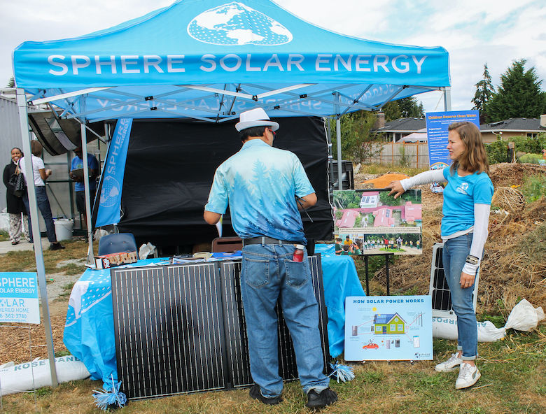 Briannah Risslen, right, Sphere Solar Energy’s Business Coordinator, talking to a visitor at the Burien Solar Punk Festival
